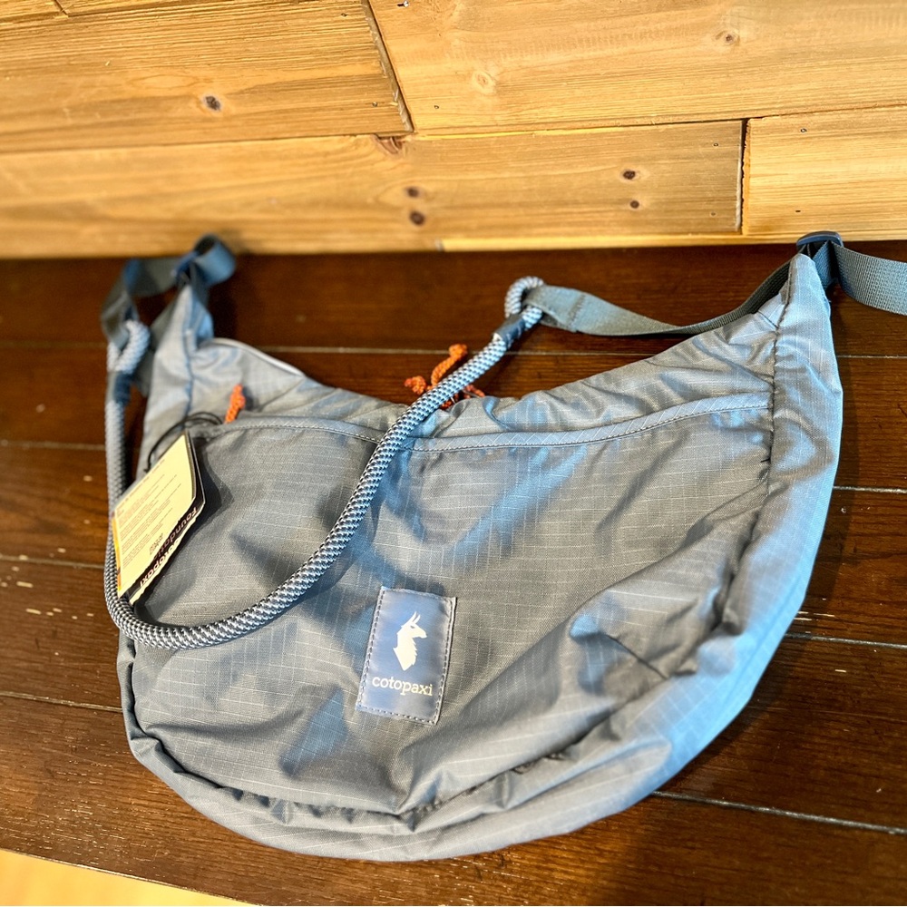 cotopaxi light blue crossbody sling bag with rope strap